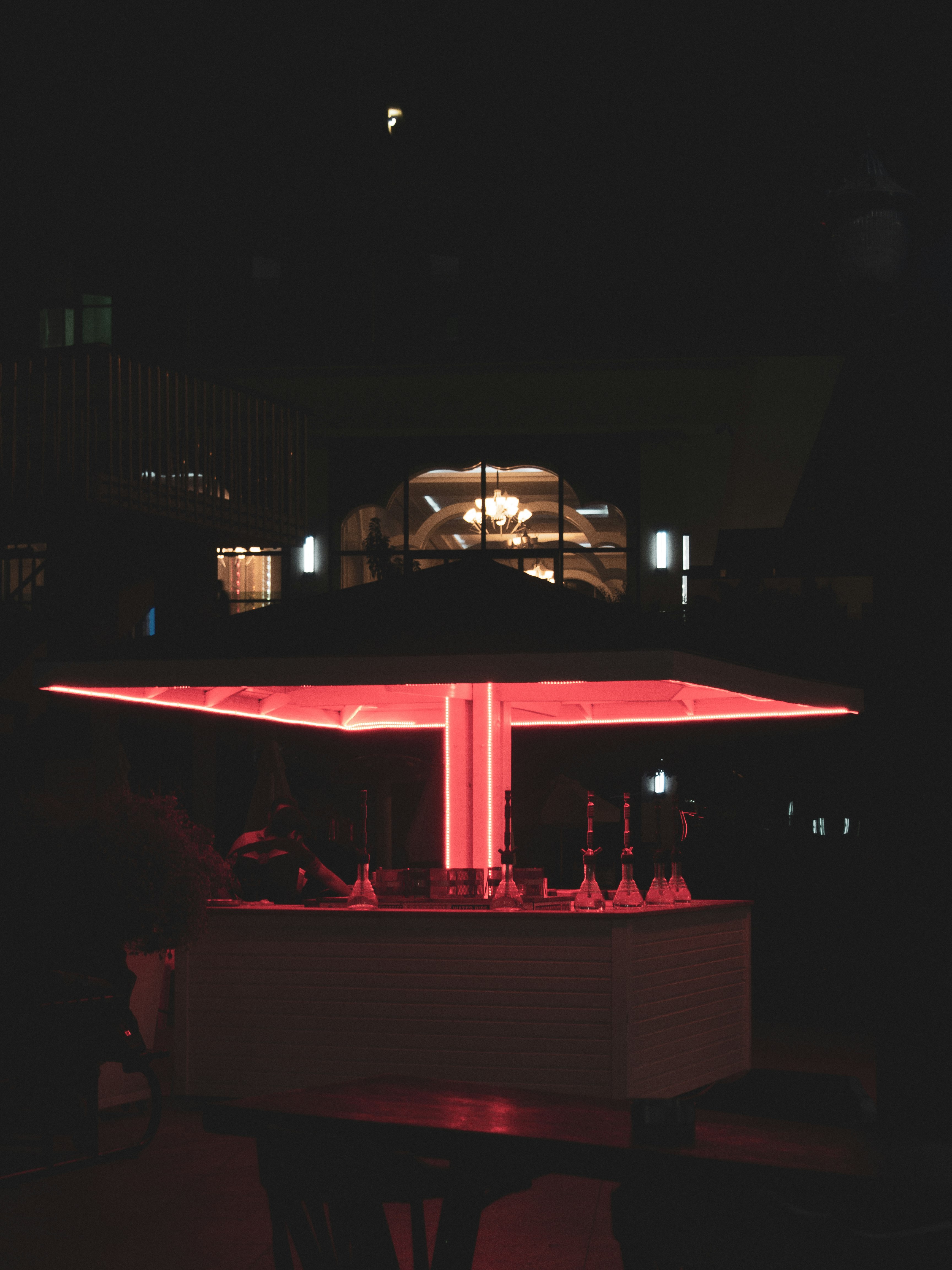 people standing on red and white tent during night time